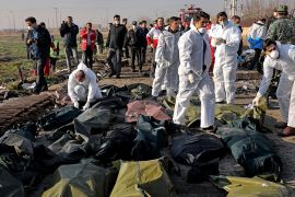 Forensic investigators work at the scene of a Ukrainian plane crash as bodies of victims are collected, in Shahedshahr, southwest of the capital Tehran, Iran, Wednesday, Jan. 8, 2020. A Ukrainian airp