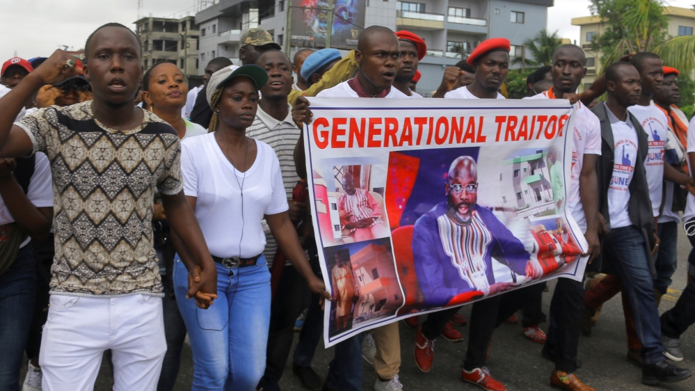 People march during a protest against corruption and economic failure in Monrovia