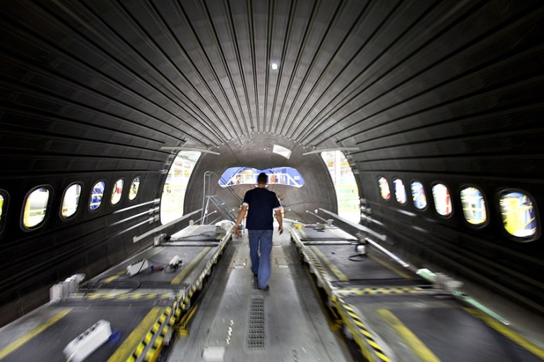 A worker walks inside a Boeing 787 composite forward fuselage section at Spirit AeroSystems in Wichita, Kansas, U.S., on Thursday, March 11, 2010