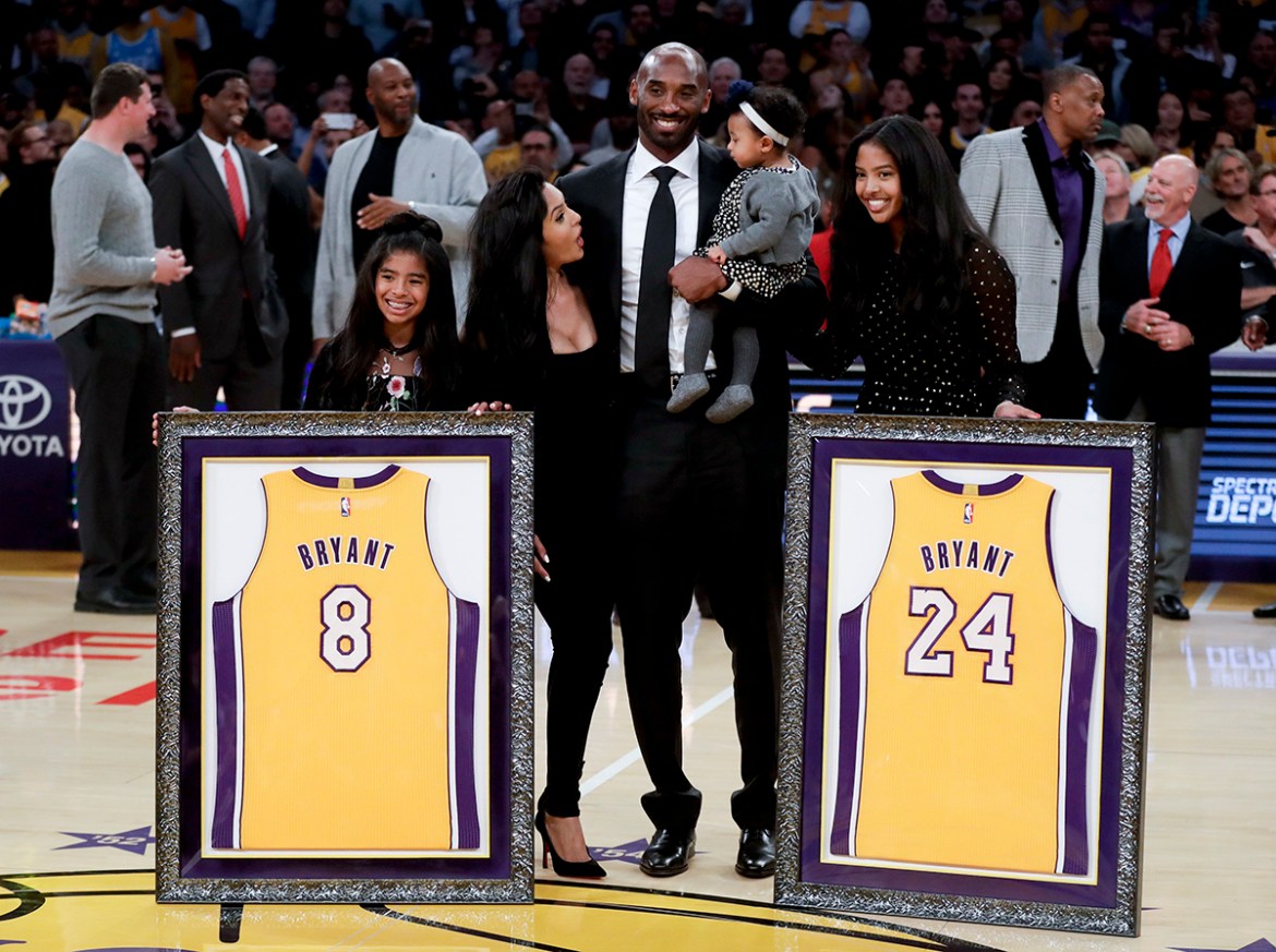 Former Los Angeles Laker Kobe Bryant poses with his family during an NBA basketball game between the Los Angeles Lakers and the Golden State Warriors in Los Angeles, Monday, Dec. 18, 2017. The Lakers