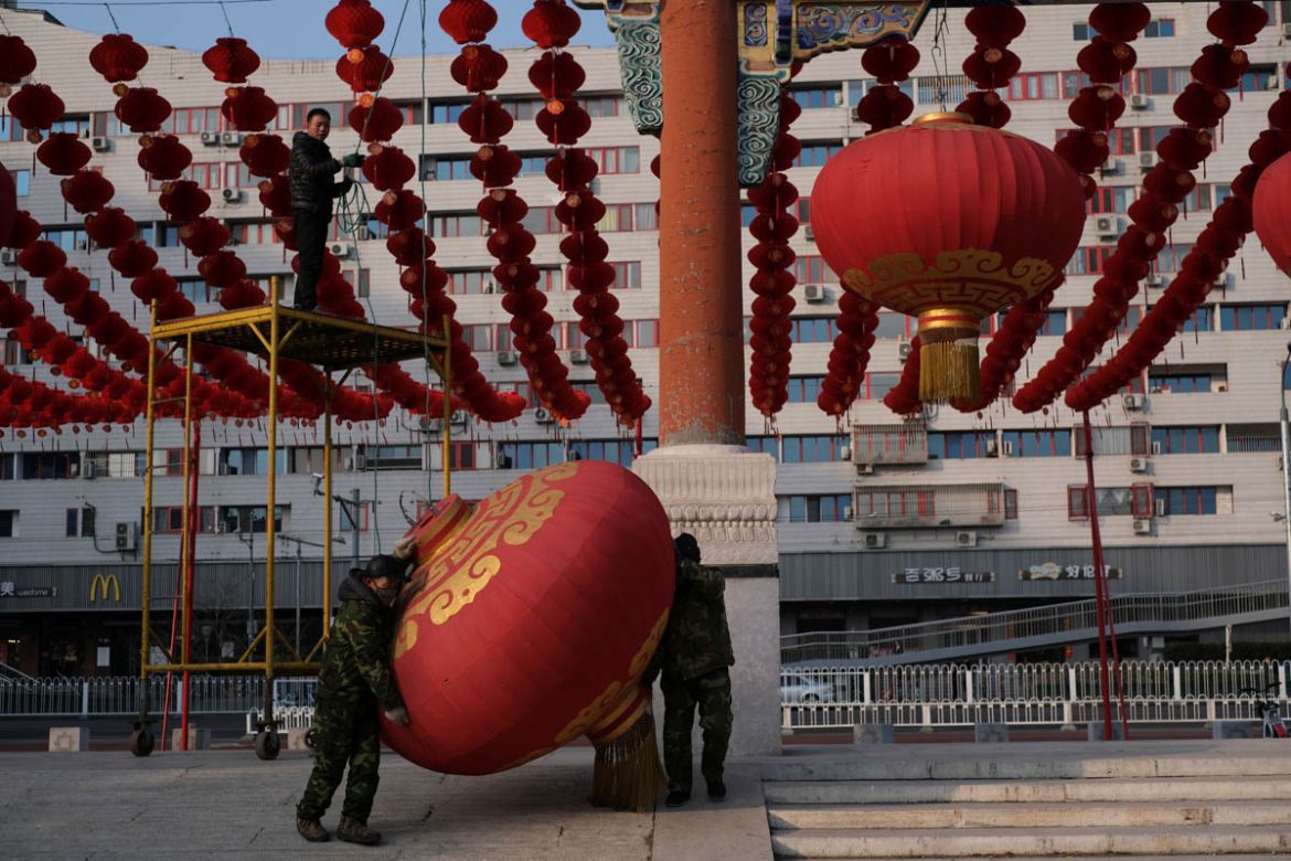 Workers dismantle decorations after the temple fair for the Chinese Lunar New Year in Ditan Park was canceled in Beijing, China January 24, 2020. REUTERS/Carlos Garcia Rawlins TPX IMAGES OF THE DA