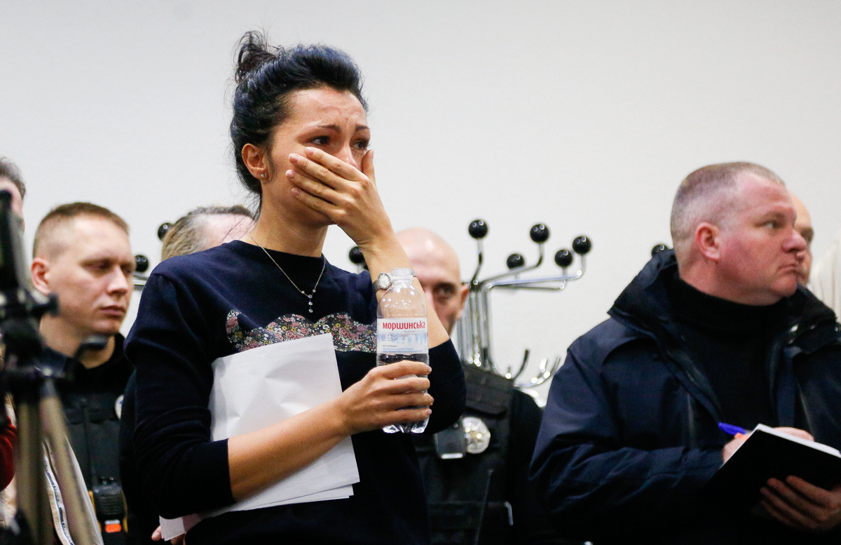 A Ukrainian International Airline company worker reacts during a briefing at Borispil international airport outside Kyiv, Ukraine, Wednesday, Jan. 8, 2020. A Ukrainian airplane carrying 176 people cra