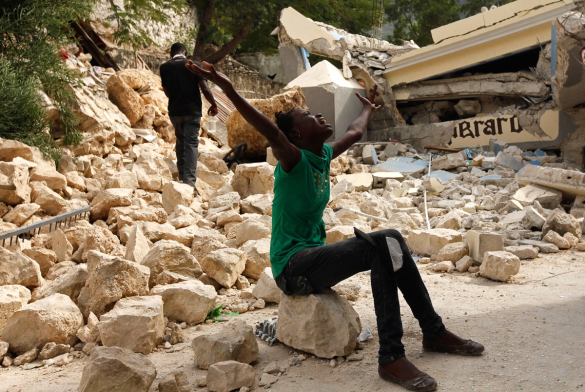 Cindy Terasme screams after seeing the feet of her dead 14-year-old brother Jean Gaelle Dersmorne in the rubble of the collapsed St. Gerard School in Port-au-Prince, Haiti, Thursday, Jan. 14, 2010. A
