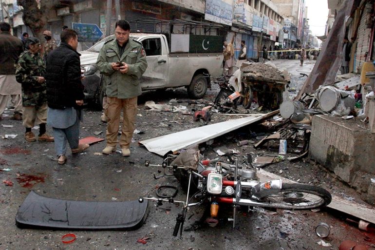 Pakistani police officers examine the site of a bomb explosion in Quetta, Pakistan, Tuesday, Jan. 7, 2020. A powerful roadside bomb exploded near a vehicle carrying Pakistani security forces in the co