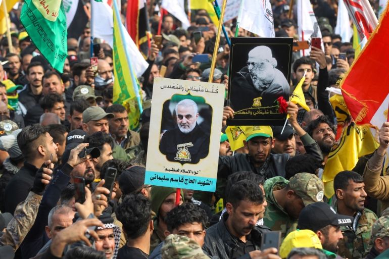 Supporters of the Hashed al-Shaabi paramilitary force and Iraq''s Hezbollah brigades attend the funeral of Iranian military commander Qasem Soleimani (portrait) and Iraqi paramilitary chief Abu Mahdi a