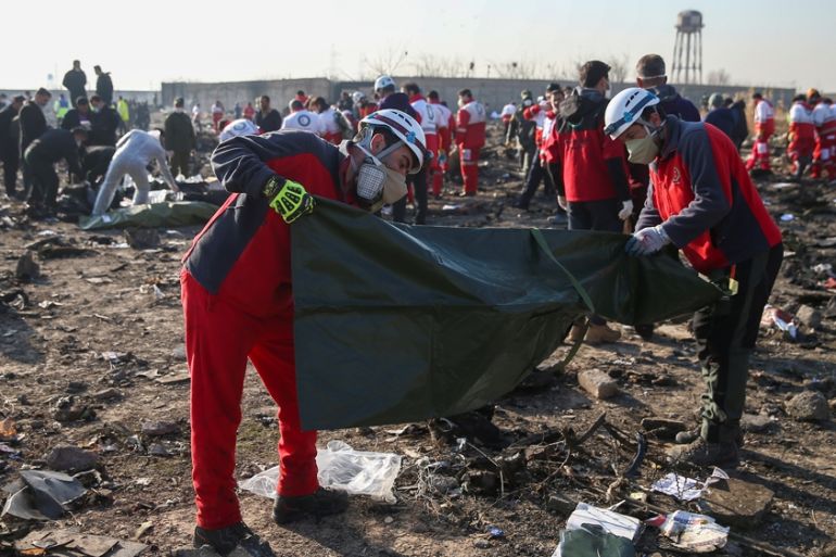 DATE IMPORTED: 08 January, 2020 Red Crescent workers check plastic bags at the site where the Ukraine International Airlines plane crashed after take-off from Iran''s Imam Khomeini airport