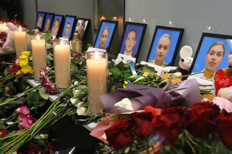 Flowers and candles are placed in front of portraits of the flight crew members of the Ukrainian 737-800 plane that crashed on the outskirts of Tehran, at a memorial inside Borispil international airp