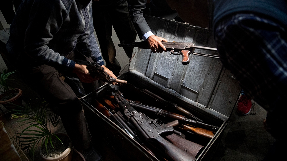 Assam police personnel pack up arms and ammunition handed over by cadres of different rebel groups after a surrender ceremony in Gauhati, India, Thursday, Jan. 23, 2020. More than 600 insurgents belon