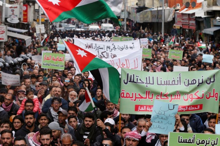 Demonstrators hold Jordanian national flags and chant slogans during a protest against a government''s agreement to import natural gas from Israel, in Amman