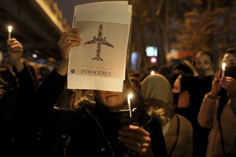 People gather for a candlelight vigil to remember the victims of the Ukraine plane crash, at the gate of Amri Kabir University that some of the victims of the crash were former students of, in Tehran,