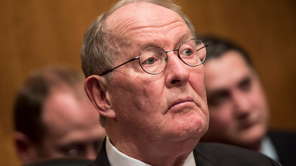 Committee chairman Senator Lamar Alexander (R-TN) listens while  Betsy DeVos speaks during her confirmation hearing for Secretary of Education before the Senate Health, Education, Labor, and Pensions 