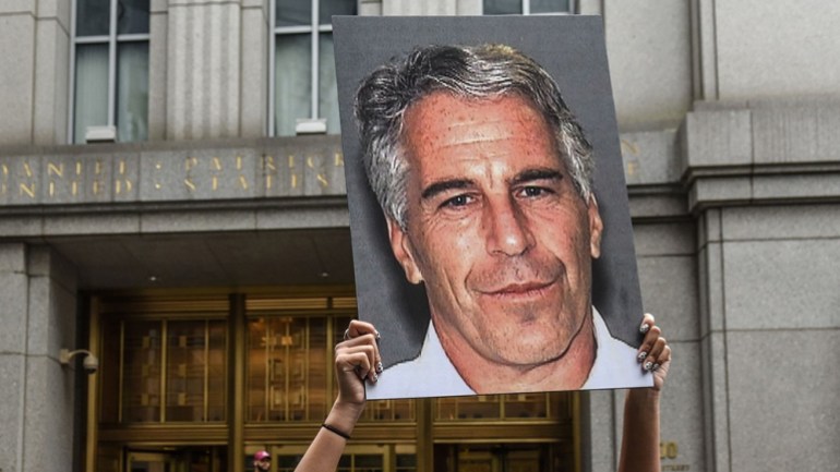 A protester holds up a sign of Jeffrey Epstein in front of the federal courthouse in New York in 2019