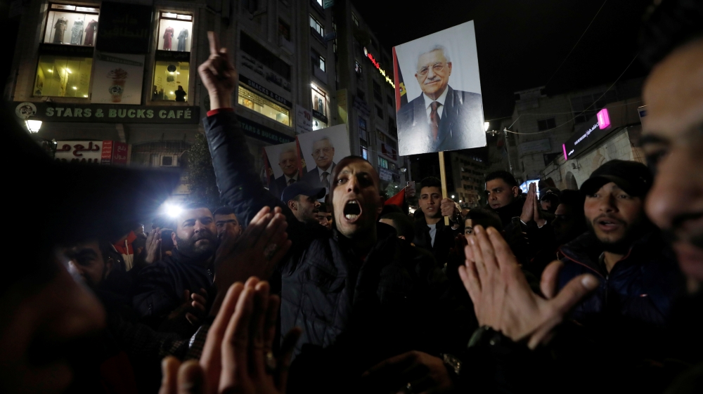 Demonstrators hold pictures of Palestinian President Mahmoud Abbas during a protest against the U.S. President Donald Trump's Mideast peace plan, in Ramallah in the Israeli-occupied West Bank