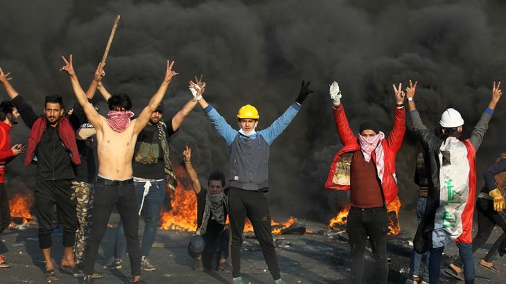 Iraqi protesters flash victory signs amid clashes with riot police following a demonstration at Baghdad''s Tayaran Square, east of Tahrir Square, on January 20, 2020. - Three Iraqi protesters were kill
