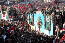 Coffins of Gen. Qassem Soleimani and others who were killed in Iraq by a U.S. drone strike, are carried on a truck surrounded by mourners during a funeral procession, in the city of Kerman, Iran, Tues