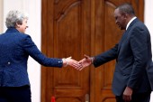 Then British Prime Minister Theresa May is greeted by Kenya's President Uhuru Kenyatta at the State House in Nairobi, Kenya August 30, 2018 [Baz Ratner/Reuters]