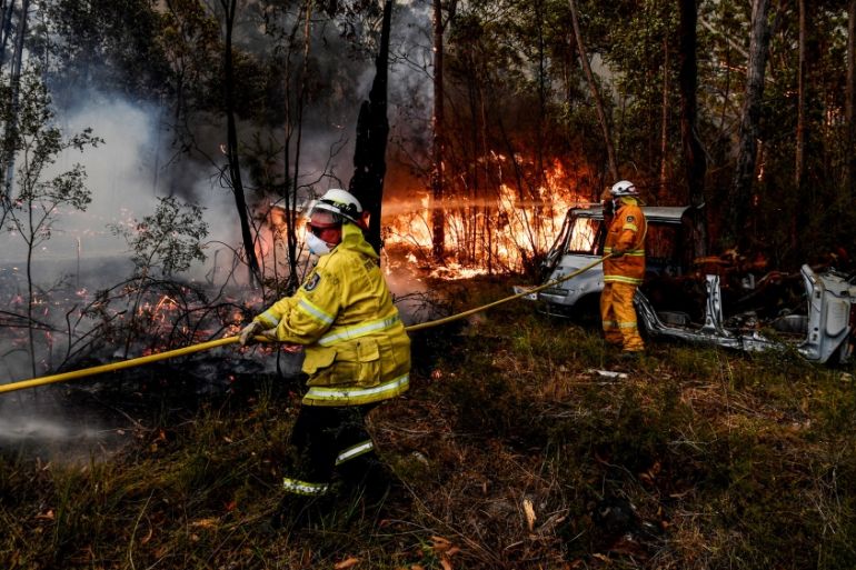 Rural Fire Service (RFS) firefighters conduct property protection near the town of Sussex Inlet on December 31, 2019 in Sydney, Australia. There are a number of dangerous bushfires burning at emergenc