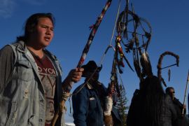 Tatanka Itancan Lone Eagle, a Fort Laramie treaty rider, holds a sacred staff during a ceremony to welcome other riders to the group in their communal encampment in Harrison, Nebraska