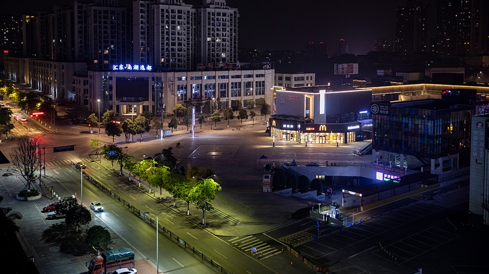 A night view of a plaza that is normally packed with mall-goers, but now due to the effective lockdown across China, most places are empty. [Shawn Yuan/Al Jazeera]
