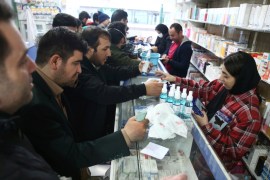 Iranians buy protective masks in a drug store to prevent contracting a coronavirus, in Tehran