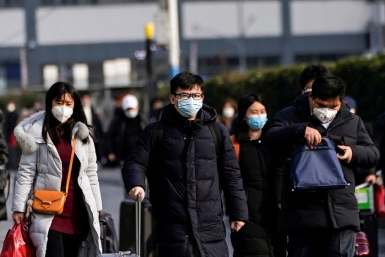 Passengers wearing masks walk at the Shanghai railway station in China, as the country is hit by an outbreak of the novel coronavirus, February 9, 2020. REUTERS/Aly Song