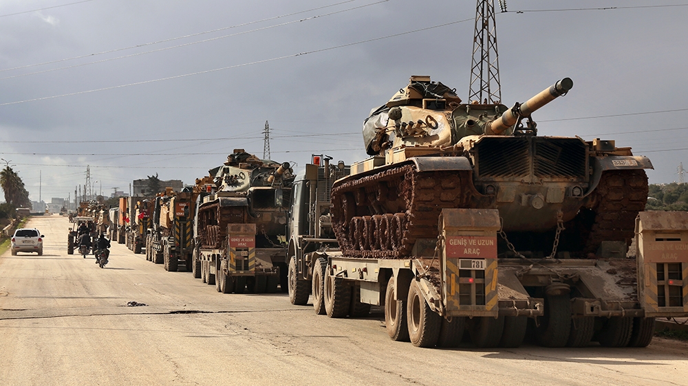 Turkish military convoy drives through the village of Binnish, in Idlib province, Syria, Saturday, Feb. 8, 2020. Several Turkish armored vehicles and tanks entered rebel-controlled northwestern Syria 