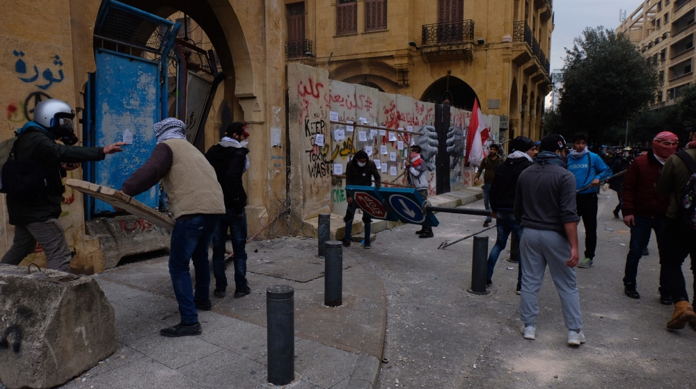 Protesters attempt to break into Beirut's Nejmeh Square, the seat of parliament. 