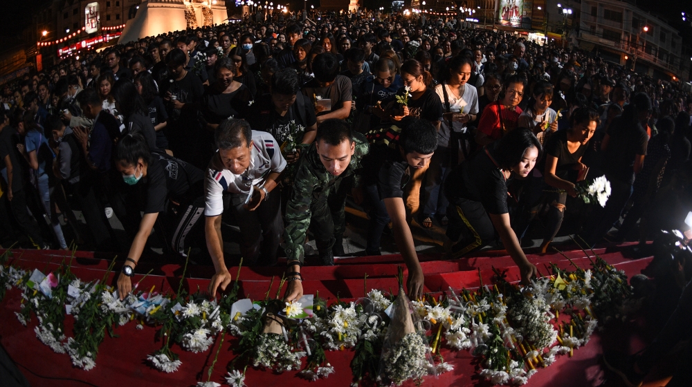People lay down flowers at a vigil for victims following a deadly mass shooting in Nakhon Ratchasima on February 9, 2020. A Thai soldier who killed at least 26 people before being shot dead in a mall 