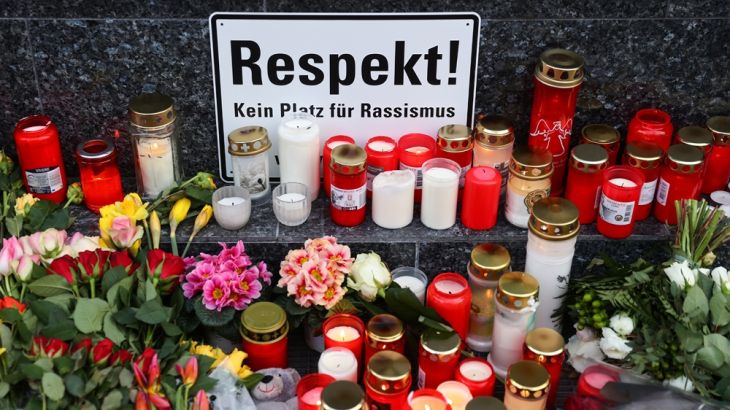 Candles and flowers are pictured during a vigil for the victims of a shooting, in Hanau, near Frankfurt, Germany, February 21, 2020. REUTERS/Kai Pfaffenbach