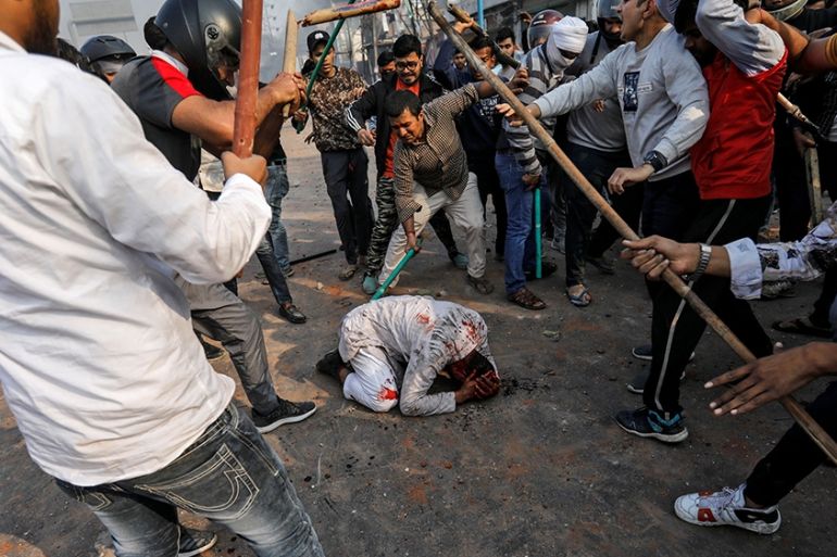 SENSITIVE MATERIAL. THIS IMAGE MAY OFFEND OR DISTURB People supporting the new citizenship law beat a Muslim man during a clash with those opposing the law in New Delhi, India, February 24, 2020. R