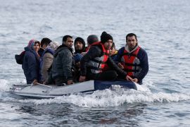 Migrants from Afghanistan on a dinghy approach a beach near the village of Skala Sikamias on the island of Lesbos