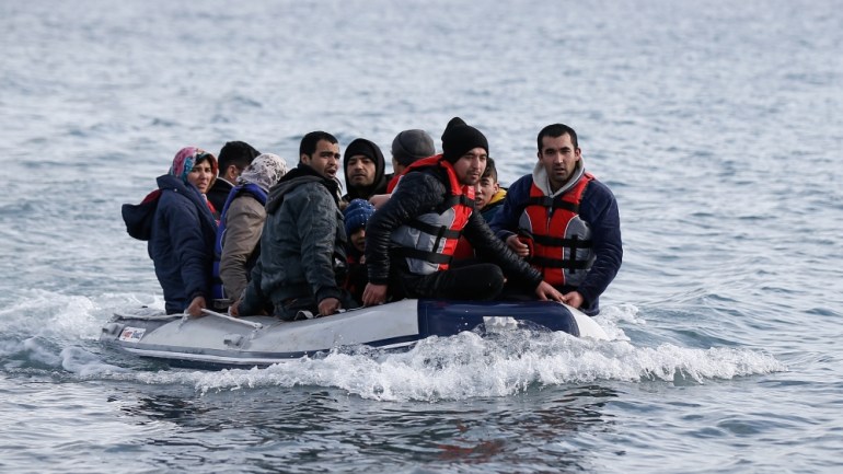 Migrants from Afghanistan on a dinghy approach a beach near the village of Skala Sikamias on the island of Lesbos