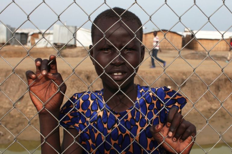 An internally displaced girl poses for a photo in the Protection of Civilians site in the UN base in Bentiu