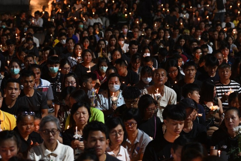 People take part in a candle light vigil for victims following a mass shooting in Nakhon Ratchasima on February 9, 2020. A Thai soldier who killed at least 26 people before being shot dead in a mall b