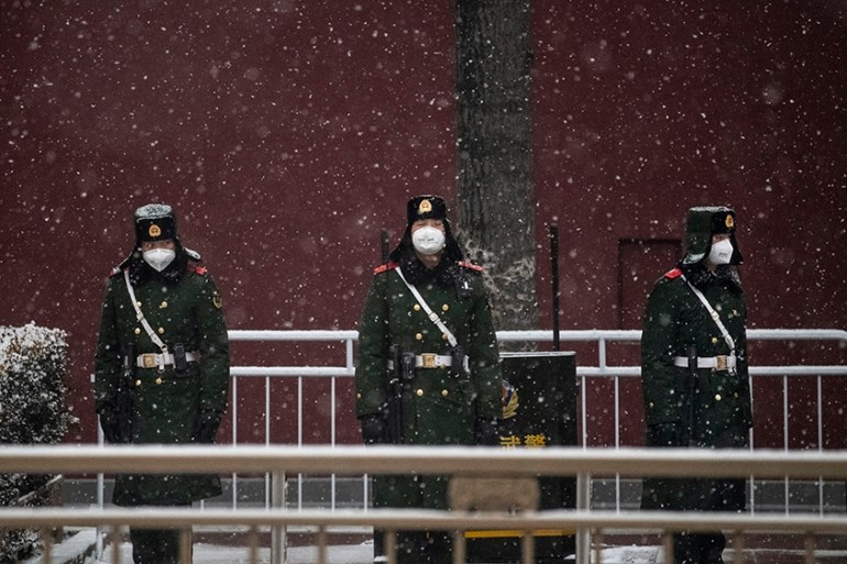 BEIJING, CHINA - FEBRUARY 05: Chinese police wear protective masks as they stand on the main road leading to Tiananmen Square on February 5, 2020 in Beijing, China. (Photo by Kevin Frayer/Getty Image