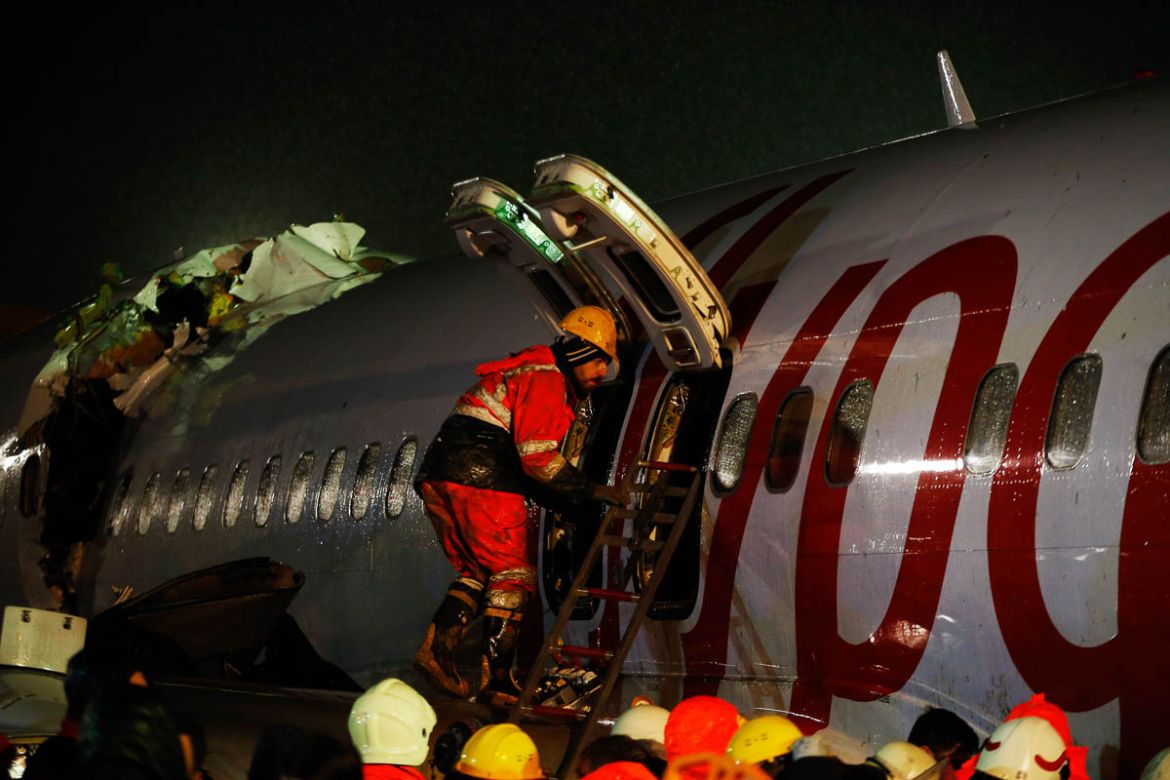 Rescue members and firefighters around the wreckage of a plane after it skidded off the runway at Istanbul''s Sabiha Gokcen Airport, in Istanbul, Wednesday, Feb. 5, 2020. The plane skidded off the runw