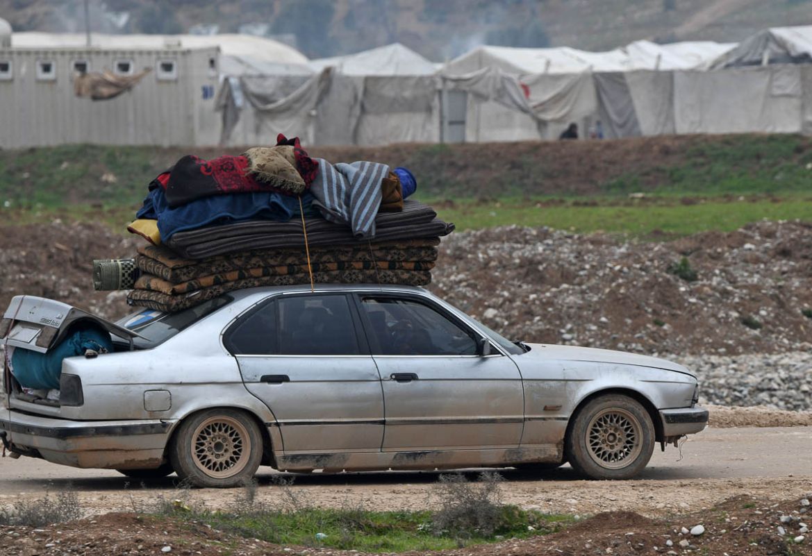 Displaced Syrians arrive at a camp for the internally displaced near Dayr Ballut, near the Turkish border in the rebel-held part of Aleppo province on February 11, 2020 after fleeing their homes in Id