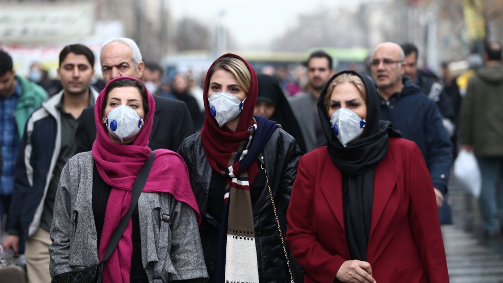 Iranian women wearing protective masks to prevent  contracting a coronavirus walk at Grand Bazaar in Tehran