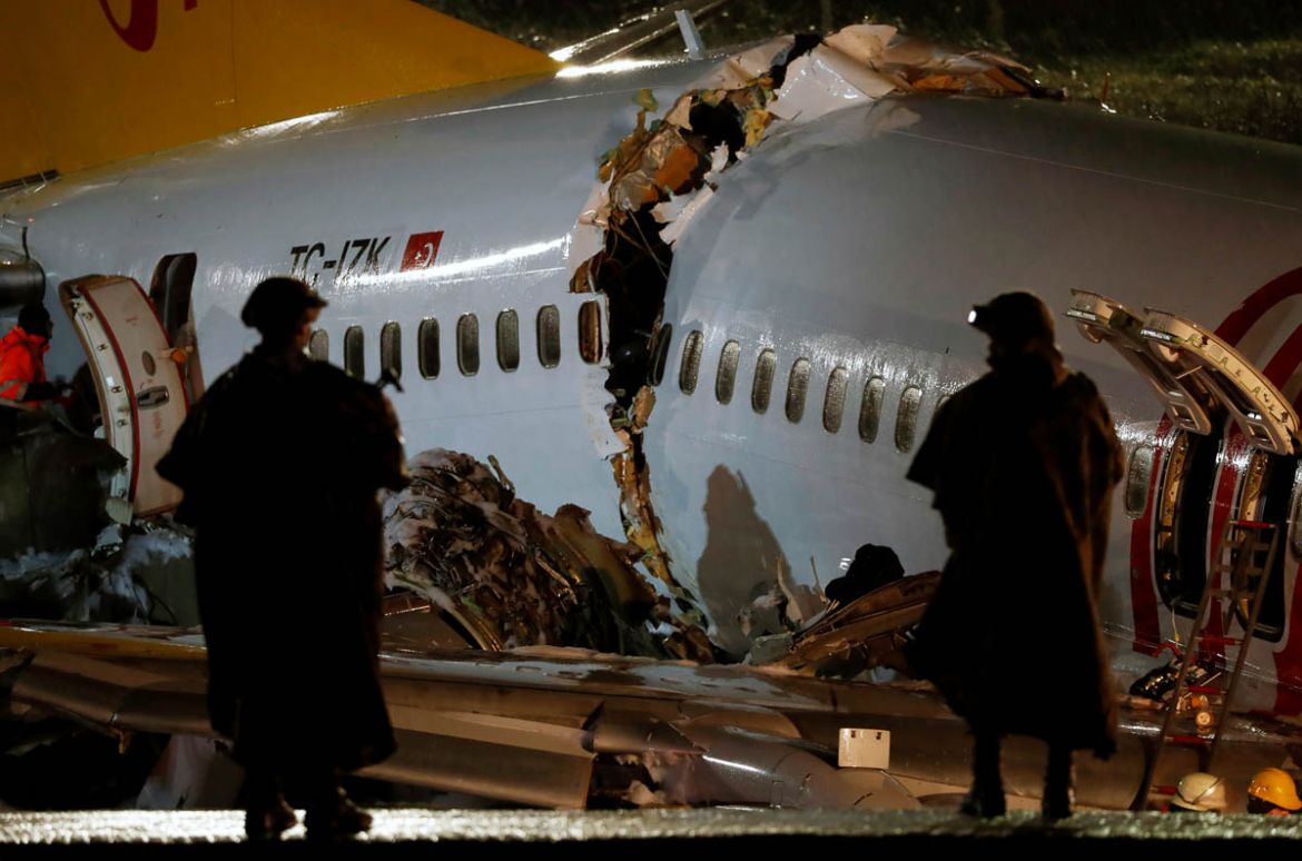 Security personnel stand near the Pegasus Airlines Boeing 737-86J plane, that overran the runway during landing and crashed, at Istanbul''s Sabiha Gokcen airport, Turkey February 5, 2020. REUTERS/Murad