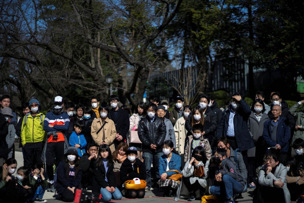 People wearing protective masks are seen at the Ueno park, following an outbreak of the novel coronavirus, in Tokyo, Japan, February 23, 2020. REUTERS/Athit Perawongmetha - RC2A6F9ZYH1L