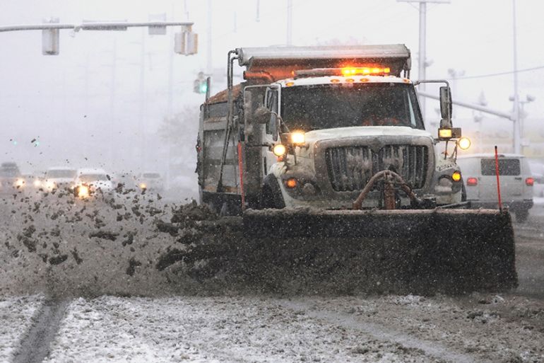 A snowplow clears a street as snow fall hampers the morning commute Friday, Jan. 17, 2020, in Salt Lake City. The storm dropped up to five inches (13 centimeters) within about four hours, said Nationa
