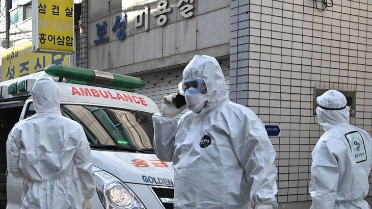 South Korean medical workers wearing protective gear visit a residence of people with suspected symptoms of the COVID-19 coronavirus to take samples, near the Daegu branch of the Shincheonji Church of