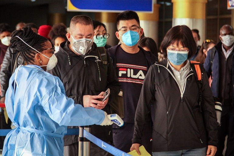 Passengers arriving on a China Southern Airlines flight from Changsha in China are screened for the new type of coronavirus, whose symptoms are similar to the cold or flu and many other illnesses, upo