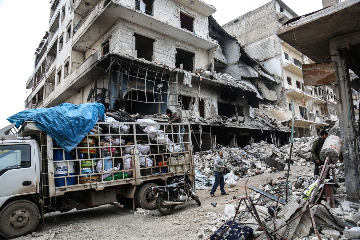 IDLIB, SYRIA - JANUARY 30 : Locals load their belongings, that remained usable, onto a truck after Russian warplanes hit residential areas in Idlib, a de-escalation zone in northwestern Syria on Janua
