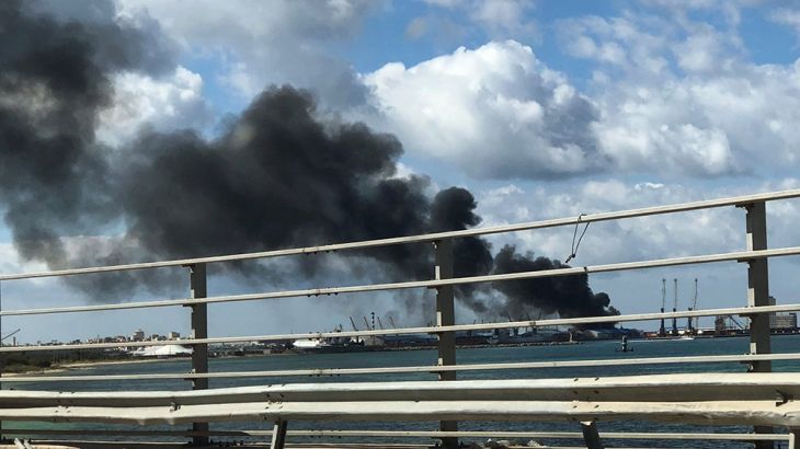 A smoke rises from a port of Tripoli after being attacked in Tripoli, Libya February 18, 2020. REUTERS/Ahmed Elumami