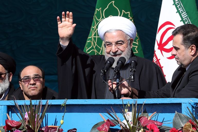 epa08210618 Iranian president Hassan Rouhani (C) waves to the crowd during a ceremony marking the 41st anniversary of the 1979 Islamic Revolution, at the Azadi (Freedom) square in Tehran, Iran, 11 Feb