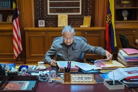 In this photo released by Prime Minister Office, Malaysian Prime Minister Mahathir Mohamad works at his office in Putrajaya, Malaysia, Tuesday, Feb. 25, 2020.