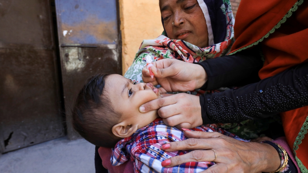 A boy receives polio vaccine drops during an anti-polio campaign in Peshawar