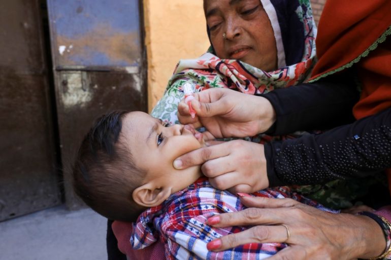 A boy receives polio vaccine drops during an anti-polio campaign in Peshawar