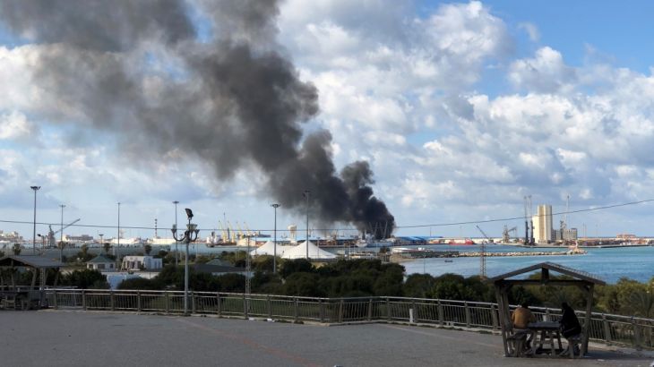 Smoke rises from a port of Tripoli after being attacked in Tripoli